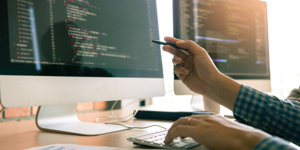 Pointing to computer screen on a desk in office. Pointing to computer screen on a desk in office.